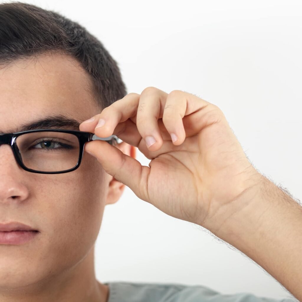Thoughtful man adjusting his glasses – individual therapy for anxiety, trauma and OCD